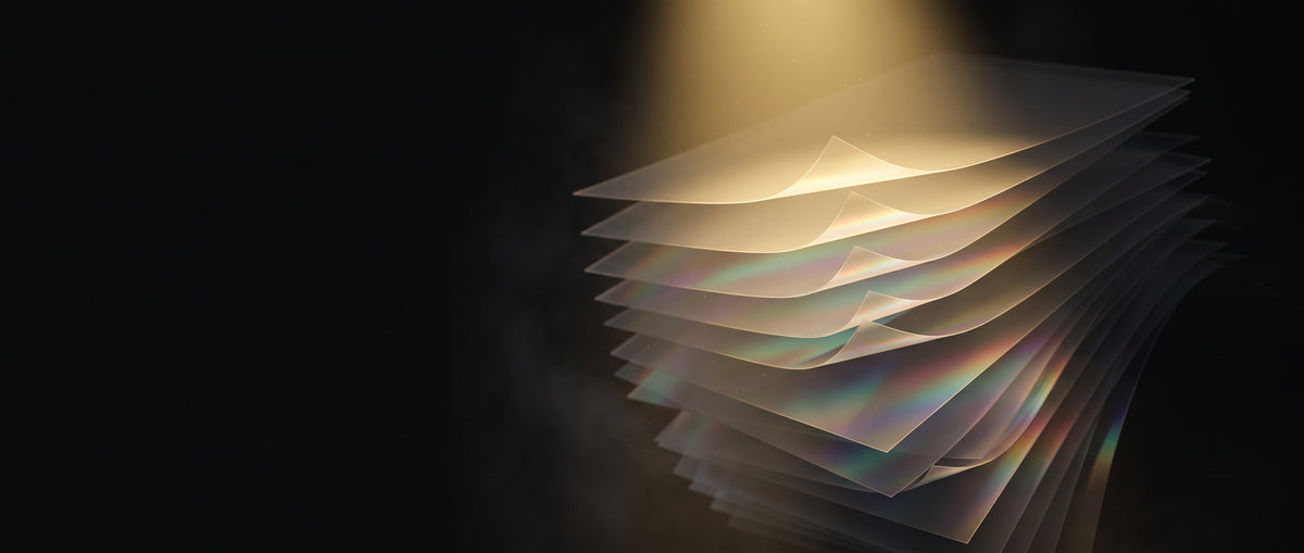 Layered translucent sheets lit by warm gold light, with clear dark space for a heading